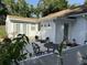 Back of house and patio area, featuring a dining set, white fence and green trim at 1339 Orchid Ave, Winter Park, FL 32789
