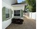 Exterior view of a home featuring gravel landscaping, green shutters, and a well-maintained side yard at 1339 Orchid Ave, Winter Park, FL 32789
