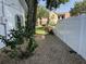 Exterior side yard showing gravel landscaping, white fence, and partial view of a nearby building at 1339 Orchid Ave, Winter Park, FL 32789