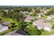 A beautiful aerial shot of a home nestled in a peaceful, green residential area surrounded by trees and landscaping at 13643 Se 89Th Ct, Summerfield, FL 34491