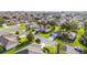 Stunning aerial view of a neighborhood with lush green lawns, mature trees, and well-maintained homes at 13643 Se 89Th Ct, Summerfield, FL 34491