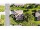Aerial view of a well-maintained home featuring a lush green yard and mature trees at 13643 Se 89Th Ct, Summerfield, FL 34491
