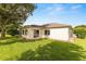 Backyard with a well-maintained lawn and partial view of the home's exterior at 13643 Se 89Th Ct, Summerfield, FL 34491