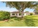 Lawn area featuring a mature shade tree and established landscaping at 13643 Se 89Th Ct, Summerfield, FL 34491