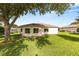 Backyard with expansive grassy area and mature trees at 13643 Se 89Th Ct, Summerfield, FL 34491