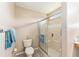 Neutral bathroom offers a walk-in shower with glass doors and updated fixtures at 13643 Se 89Th Ct, Summerfield, FL 34491
