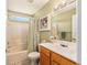 Cozy bathroom featuring single sink vanity, tile floors, and shower-tub combo at 13643 Se 89Th Ct, Summerfield, FL 34491