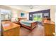 Primary bedroom suite with wood furniture, ceiling fan, and ensuite bathroom at 13643 Se 89Th Ct, Summerfield, FL 34491