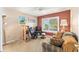 Comfortable sitting area of bedroom with ceiling fan, sofa, and recliner at 13643 Se 89Th Ct, Summerfield, FL 34491
