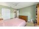 Comfortable bedroom features large closet and a large window showcasing the outdoor view at 13643 Se 89Th Ct, Summerfield, FL 34491