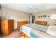 Primary bedroom suite with ceiling fan and plentiful wood storage at 13643 Se 89Th Ct, Summerfield, FL 34491
