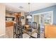 Open dining area with table, chairs, and view of the modern kitchen at 13643 Se 89Th Ct, Summerfield, FL 34491
