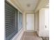 Covered front porch featuring tiled flooring and direct access to the main entrance at 13643 Se 89Th Ct, Summerfield, FL 34491