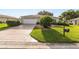 Well-manicured front yard and driveway of home at 13643 Se 89Th Ct, Summerfield, FL 34491