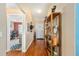Hallway with an adjacent doorway showing living area and front entry with coat rack at 13643 Se 89Th Ct, Summerfield, FL 34491