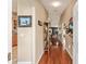 Inviting hallway featuring gleaming hardwood floors leading to the living areas at 13643 Se 89Th Ct, Summerfield, FL 34491