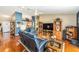 Inviting living room with hardwood floors, open layout, and view to kitchen at 13643 Se 89Th Ct, Summerfield, FL 34491