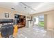 Spacious room boasts neutral walls, tiled floors and modern track lighting leading into living area at 13643 Se 89Th Ct, Summerfield, FL 34491