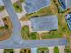 Aerial view of the property showcasing its layout, landscaping, and proximity to surrounding streets at 1406 Zest Ave, The Villages, FL 32163