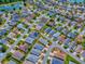 This aerial showcases homes nestled in a serene neighborhood with ponds, reflecting a peaceful community environment at 1406 Zest Ave, The Villages, FL 32163