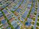 An aerial view of a quiet residential neighborhood showcasing neatly arranged single-Gathering homes and well-maintained lawns at 1406 Zest Ave, The Villages, FL 32163