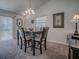 Cozy dining area with a traditional table set, neutral decor, and a window providing natural light at 1406 Zest Ave, The Villages, FL 32163