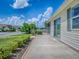 Charming one-story home featuring a well-maintained lawn and a covered patio for outdoor enjoyment at 1406 Zest Ave, The Villages, FL 32163