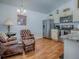 Cozy eat-in kitchen featuring stainless steel appliances, white cabinetry, and comfortable seating area with leather chairs at 1406 Zest Ave, The Villages, FL 32163