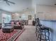 Comfortable living room features plush seating, a ceiling fan, and seamless access to the dining area and kitchen at 1406 Zest Ave, The Villages, FL 32163