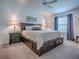 Serene main bedroom with a wooden bed frame, storage drawers, and soft carpet flooring at 1406 Zest Ave, The Villages, FL 32163