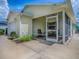 Enclosed patio with neutral furniture, accessible from both the home and the garage, offering a private outdoor space at 1406 Zest Ave, The Villages, FL 32163