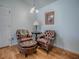 Intimate sitting area with comfortable leather chairs, side table, and natural light, perfect for reading or relaxing at 1406 Zest Ave, The Villages, FL 32163