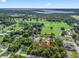 An aerial view highlights the prime location of a beautiful home near fields and a lake at 15664 Se 97Th Ave, Summerfield, FL 34491