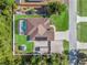 An aerial top-down view shows a fenced property with a pool, shed, gazebo, and solar panels at 15664 Se 97Th Ave, Summerfield, FL 34491