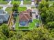 Aerial view of a fenced property with a pool, shed, gazebo, solar panels, and home orchard at 15664 Se 97Th Ave, Summerfield, FL 34491