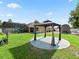 Lush backyard with swimming pool, gazebo, and shed, perfect for outdoor living at 15664 Se 97Th Ave, Summerfield, FL 34491