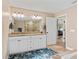 Bright bathroom features double sinks, a large mirror and an elegant glass shower with tiled floor at 15664 Se 97Th Ave, Summerfield, FL 34491