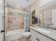 This bathroom has a tub, shower, toilet, and sink with vanity with granite counter top at 15664 Se 97Th Ave, Summerfield, FL 34491