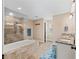 Bathroom boasting double sink vanity, walk-in shower with rainfall showerhead, and separate soaking tub at 15664 Se 97Th Ave, Summerfield, FL 34491