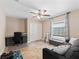 This room features a comfortable couch, closet space, window with blinds and a ceiling fan at 15664 Se 97Th Ave, Summerfield, FL 34491