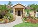 Close-up of the home's entryway, highlighting the landscaped garden and stone accents at 15664 Se 97Th Ave, Summerfield, FL 34491