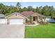 Charming single-story home featuring a well-maintained lawn and welcoming front entrance at 15664 Se 97Th Ave, Summerfield, FL 34491
