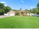 Inviting single-Gathering home with a lush green lawn and complemented by mature landscaping at 15664 Se 97Th Ave, Summerfield, FL 34491