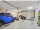 A spacious garage with ample storage space, a car and multiple entrance doors at 15664 Se 97Th Ave, Summerfield, FL 34491