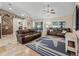 Comfortable living room featuring tile floors, vaulted ceilings, and stylish nautical-themed decor at 15664 Se 97Th Ave, Summerfield, FL 34491