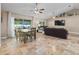 Spacious living area including a dining set, backyard access, and a comfortable living space at 15664 Se 97Th Ave, Summerfield, FL 34491