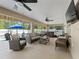 Spacious screened patio with furniture and a clear view of the outdoor pool and hot tub at 15664 Se 97Th Ave, Summerfield, FL 34491