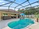 Backyard pool area with a hot tub, sun loungers, and decorative lights at 15664 Se 97Th Ave, Summerfield, FL 34491