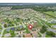 Aerial view of the community with a pond. Home marked with a red icon at 17380 Se 111Th Ct, Summerfield, FL 34491