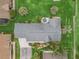 Aerial view of the home showing roof, driveway, landscaping, and other homes in the neighborhood at 17380 Se 111Th Ct, Summerfield, FL 34491